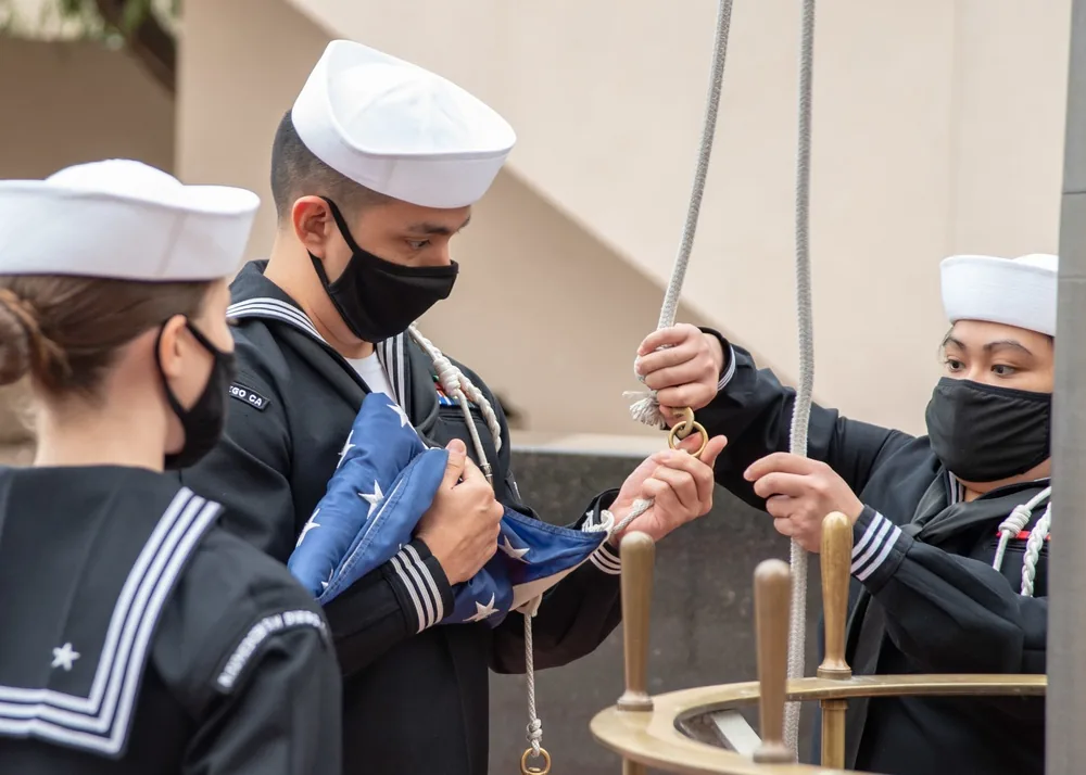 U.S. Navy flag detail attaching the National Ensign to a flagpole halyard