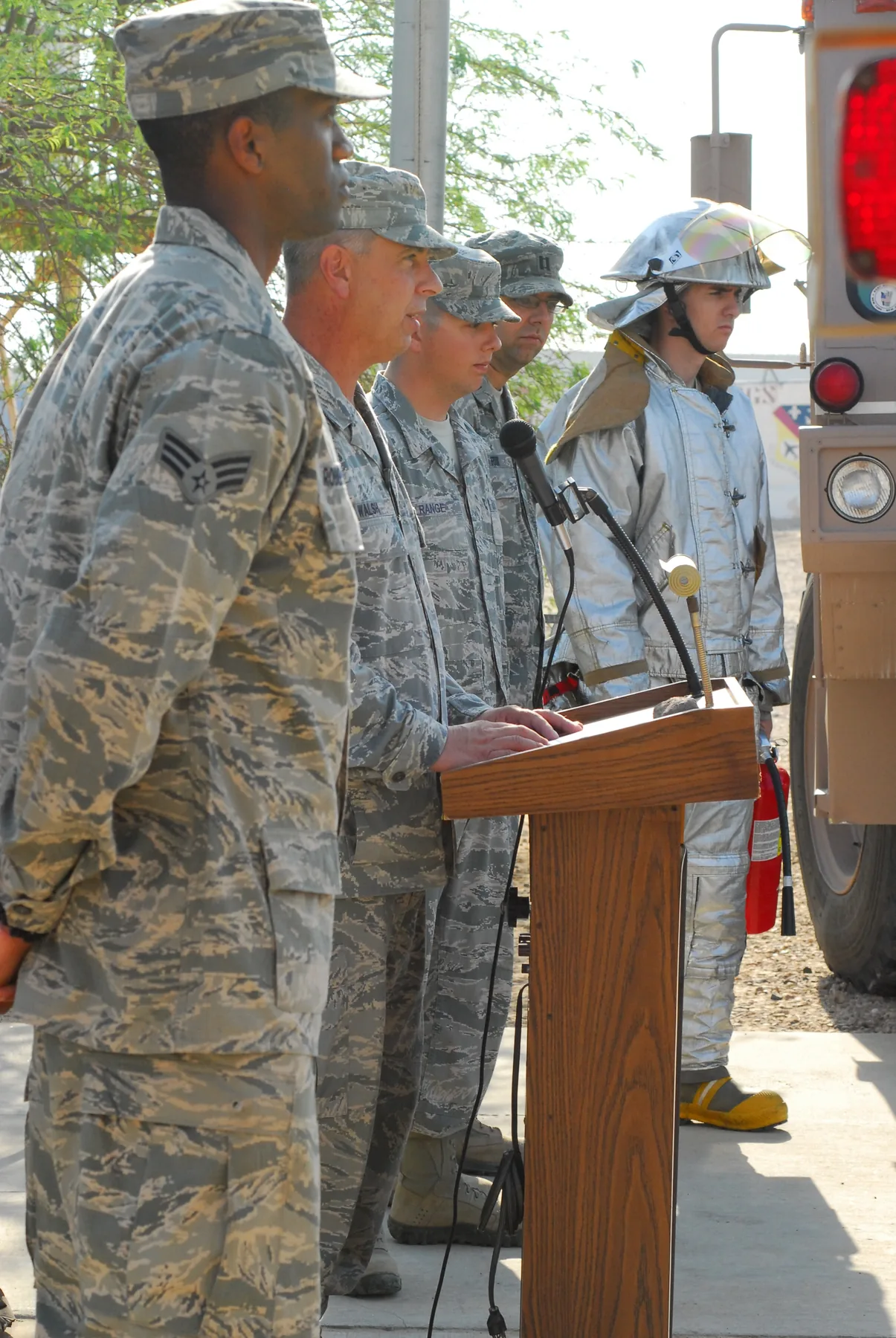 Airmen and a firefighter gathered for a National Fallen Firefighters Memorial Weekend remembrance ceremony