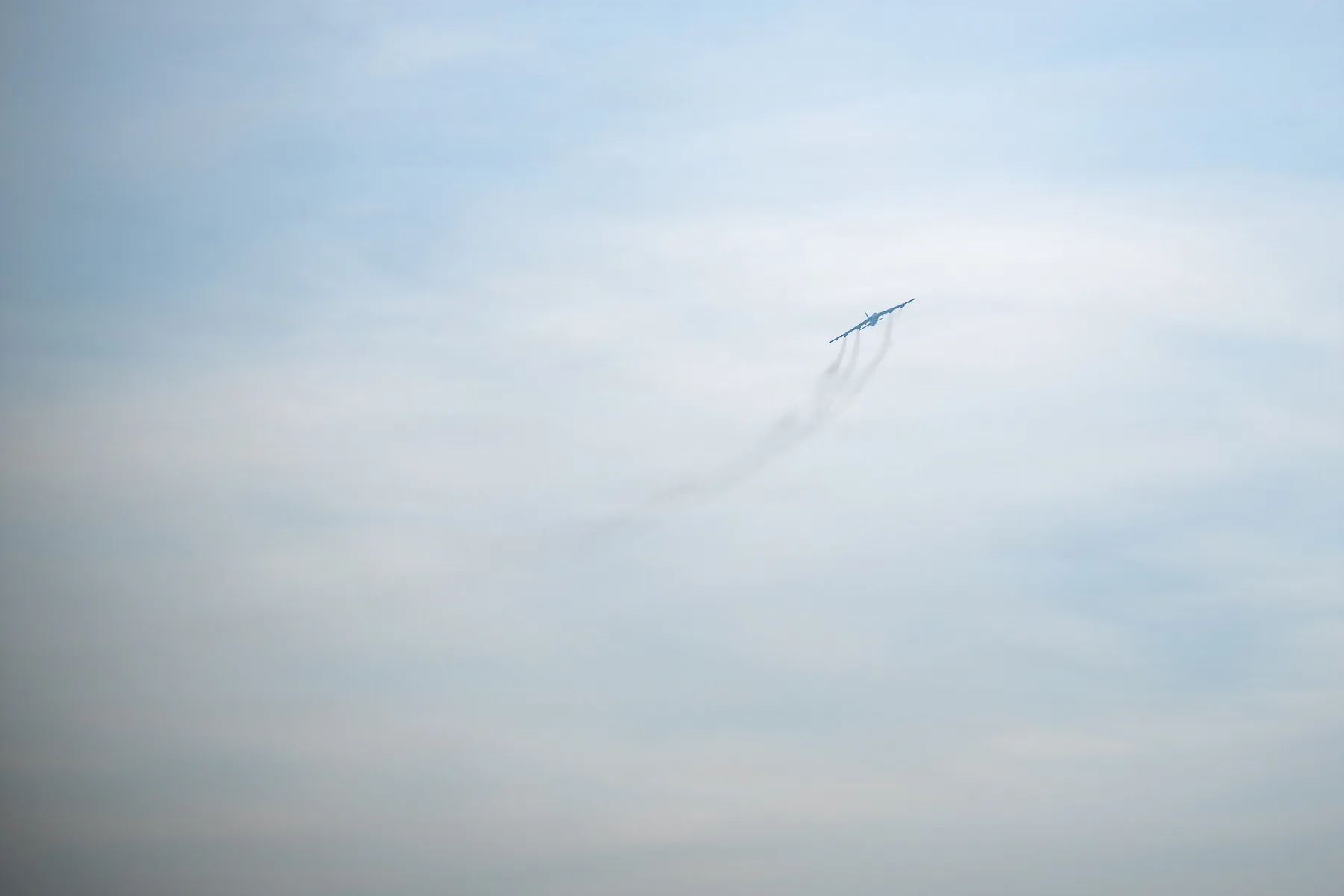 A U.S. Air Force B-52H Stratofortress flying through a cloudy sky in March 2026