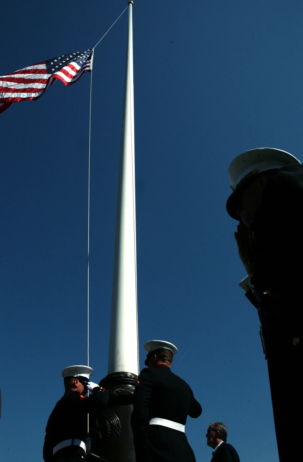 Marines raising the United States flag to full staff during a Memorial Day ceremony