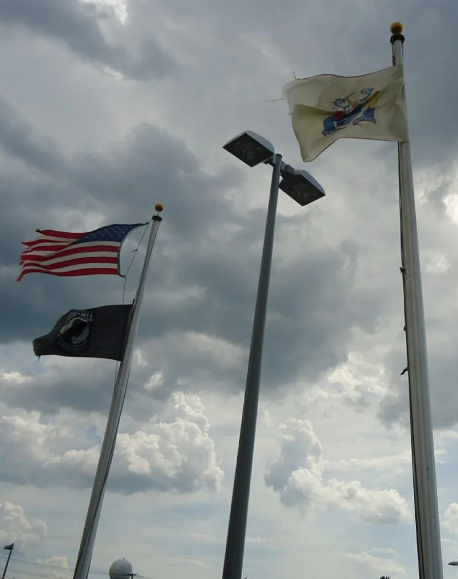 United States, New Jersey, and POW-MIA flags at a motor vehicle facility in Rahway