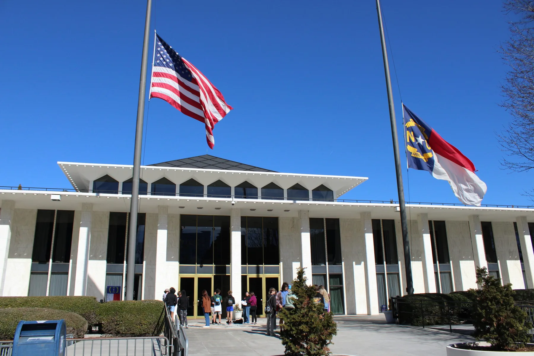 U.S. and North Carolina flags at half-staff outside the North Carolina Legislative Building in Raleigh