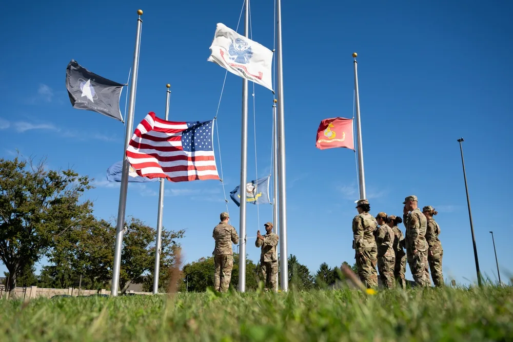 Airmen practicing a flag detail with the U.S. flag at half-staff at Dover Air Force Base