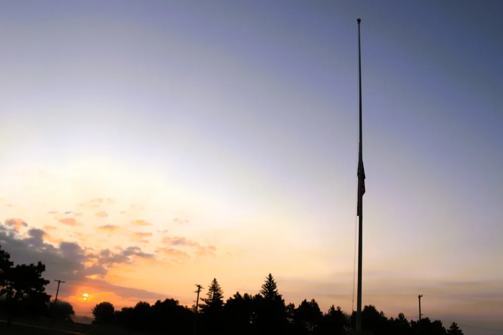 U.S. flag flying at half-staff near sunset at Fort McCoy on Patriot Day