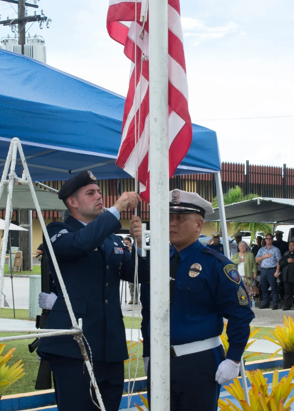 Uniformed officers raising the U.S. flag during a May 15 police memorial ceremony in Guam