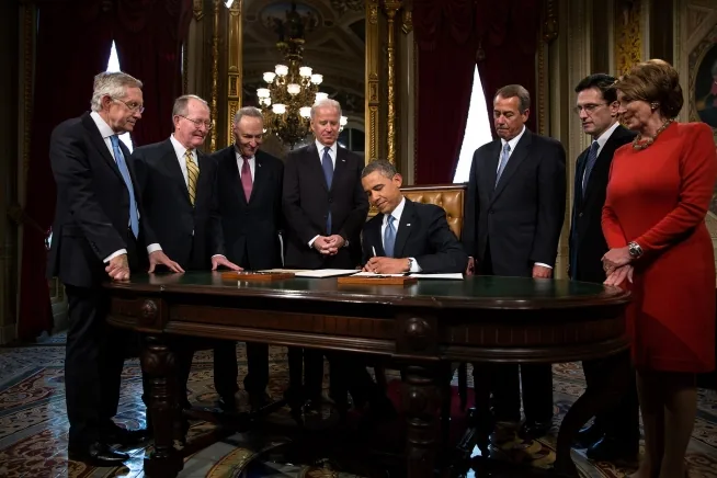 President Barack Obama signing a presidential proclamation while congressional leaders look on