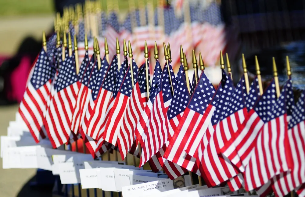 Rows of small American flags displayed at a Veterans Day ceremony in Virginia Beach
