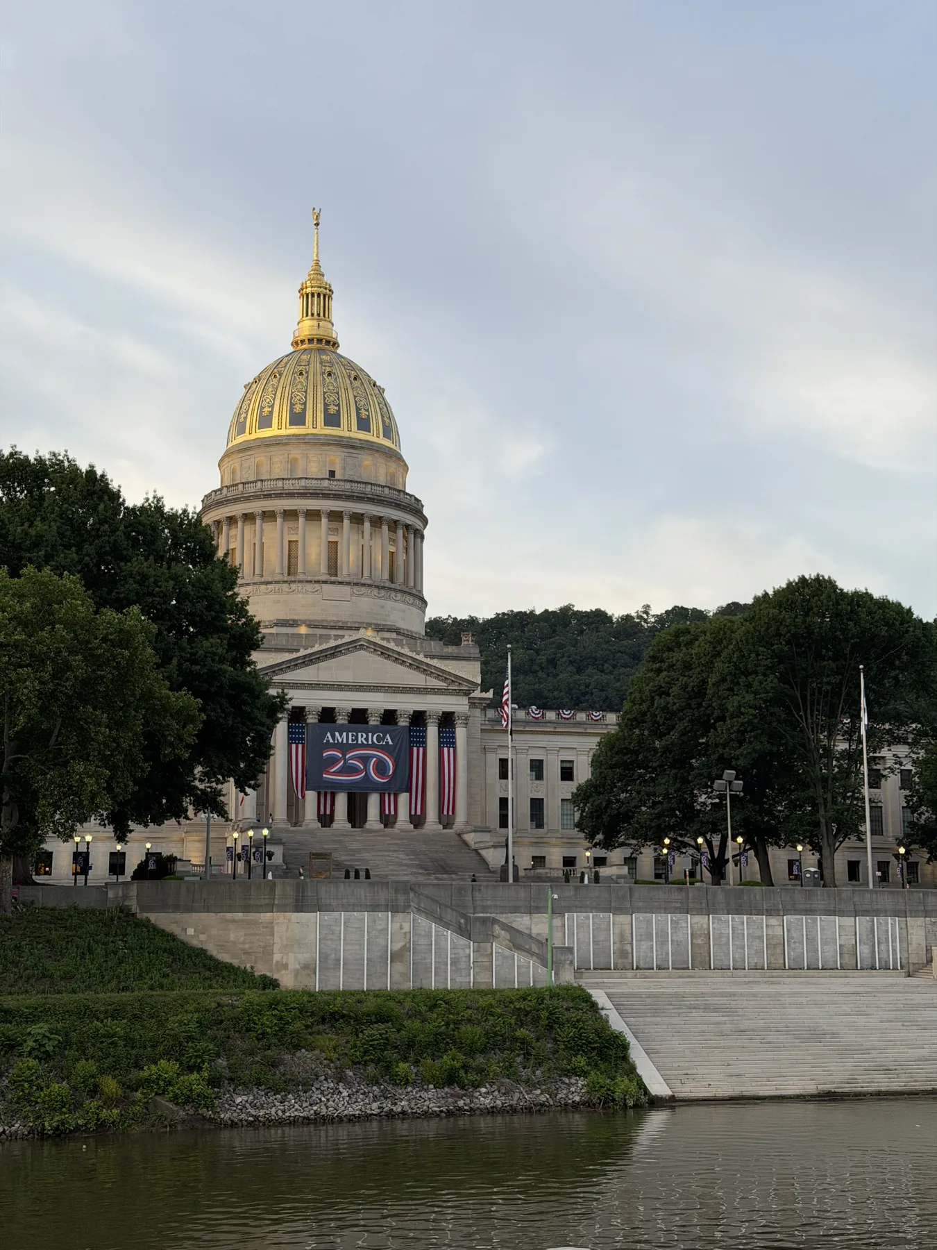American flag below the top of its pole outside the West Virginia State Capitol