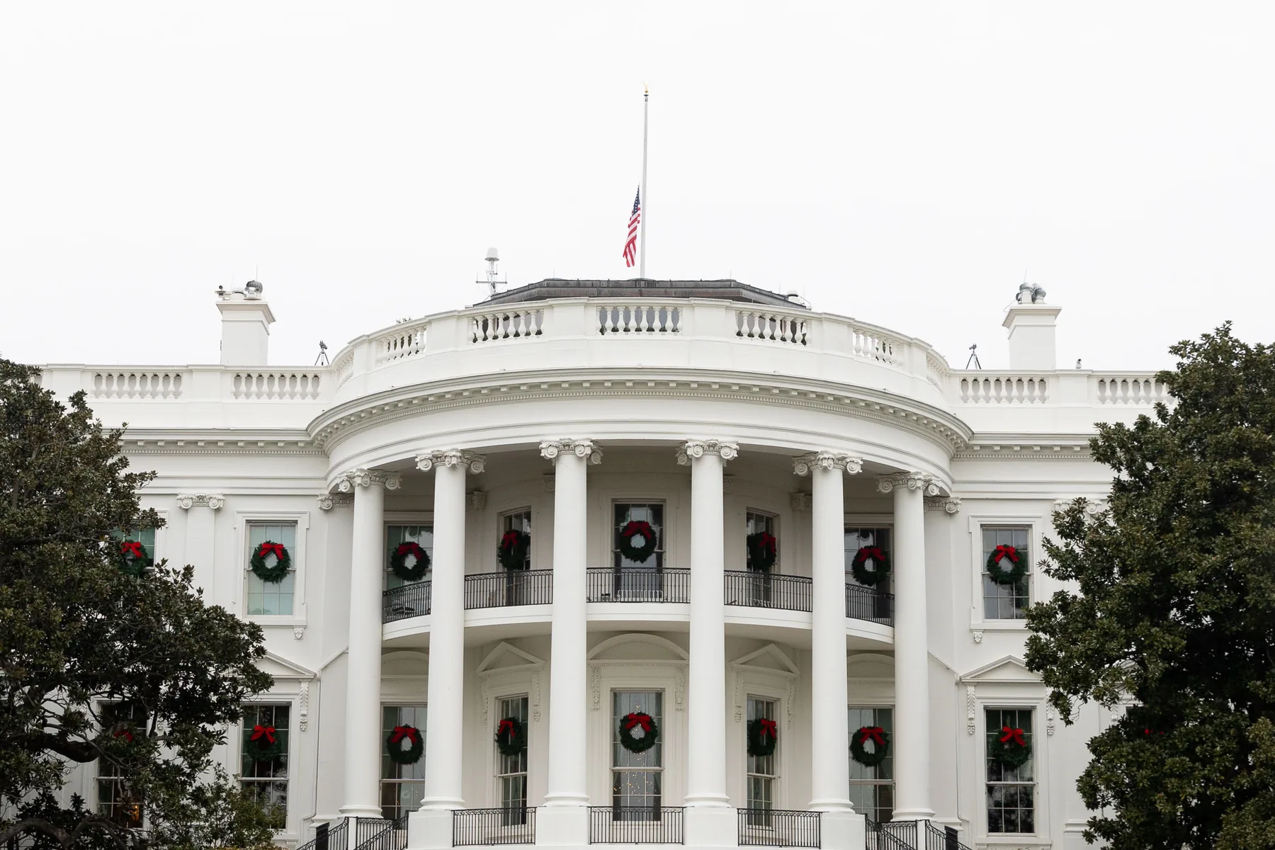 United States flag flying at half-staff above the White House in December 2018